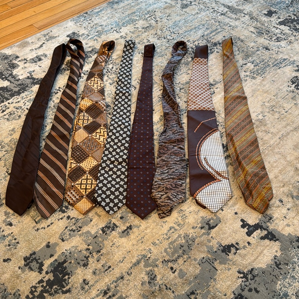 8 men’s silk ties in the brown family. They have been worn.